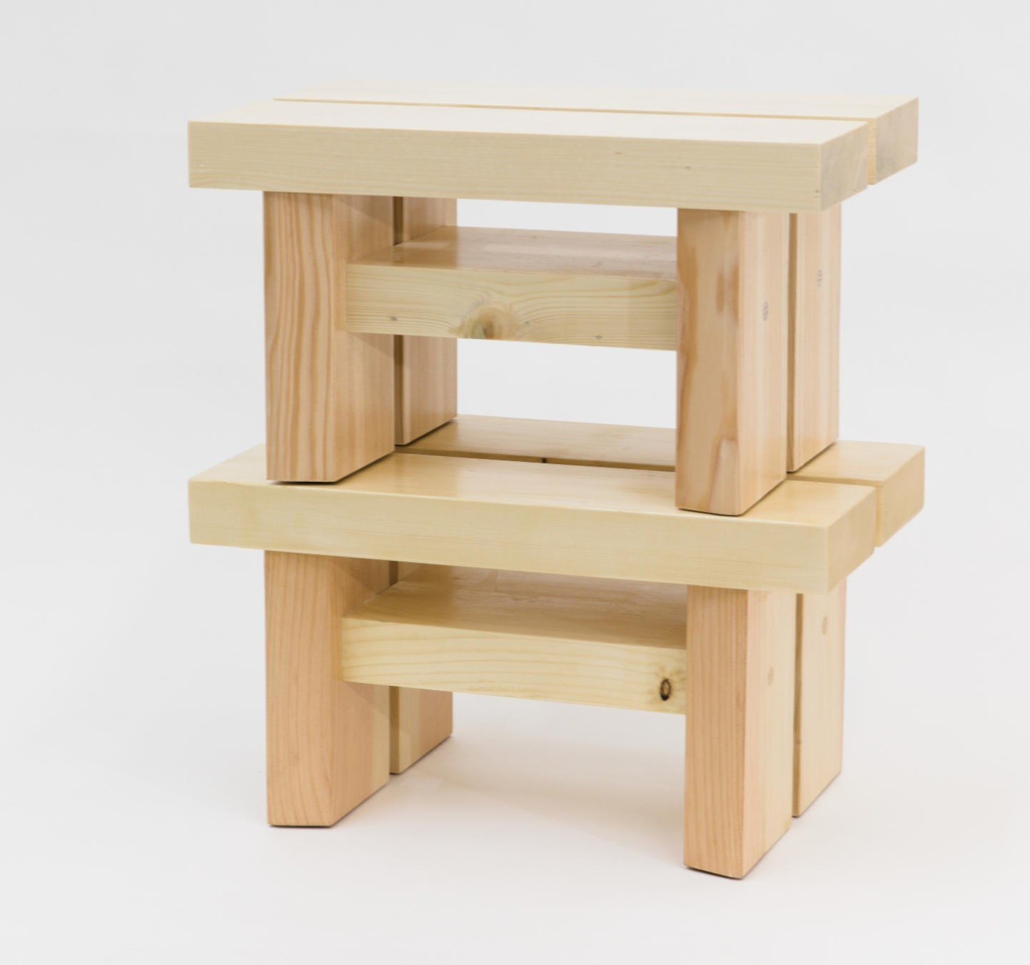 two foot benches with white wood tops and douglas fir legs - one stacked on top of the other, side view